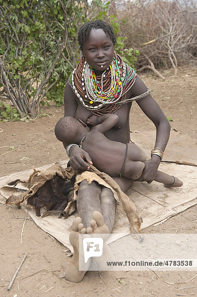 Nyangatom  Bume or Buma woman breastfeeding her child  Omo Valley  Ethiopia  Africa