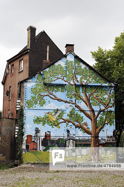 Old house about to be demolished wall painted with a tree in an industrial landscape Bruckhausen district Duisburg North Rhine-Westphalia Germany Europe