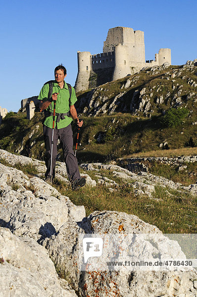 Hiker  climber or trekker in front of Rocca Calascio Castle  Campo Imperatore  Gran Sasso National Park  Abruzzo  Italy  Europe