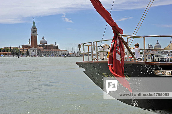 Boy on board an ocean yacht on a quay  Bacino di San Marco  San Giorgio Maggiore Church  Venezia  Venice  Italy  Europe