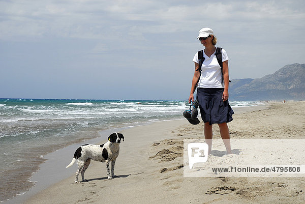 Woman with dog at Patara beach  Lycian coast  Antalya Province  Mediterranean  Turkey  Eurasia