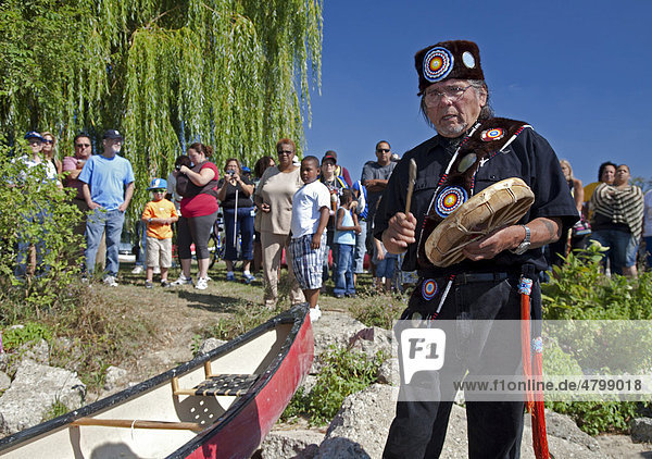 Dennis Banks  co-founder of the American Indian Movement  drums and chants as AIM members prepare to set out in canoes at a political protest action  Detroit  Michigan  USA  America