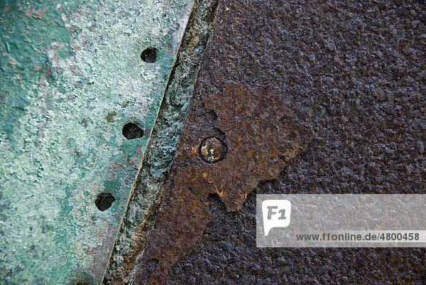 Green paint and rust on a metal plate