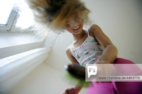 Girl  8  combing her hair