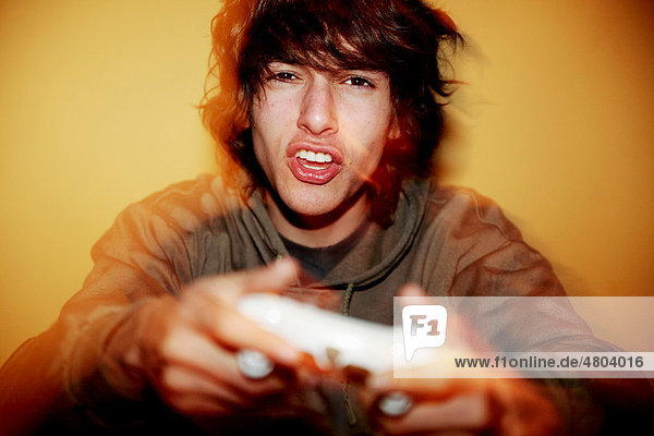 Young man with game console being annoyed about a video game