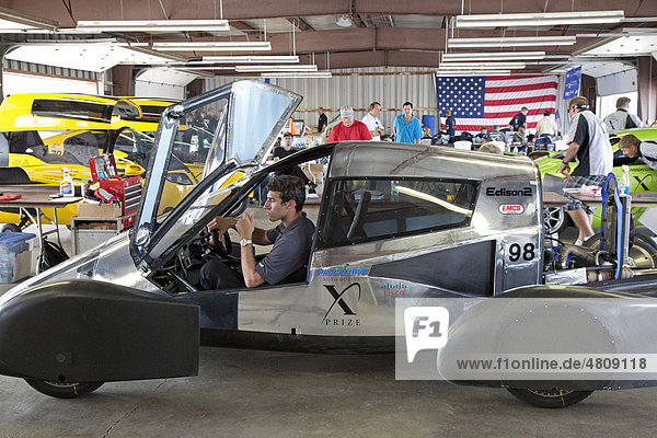 A technician works on one of the Edison2 team's Very Light Cars  Competition for the Progressive Insurance Automotive X Prize which offers $10 million for super fuel-efficient cars  at the Michigan International Speedway  Brooklyn  Michigan  USA  America