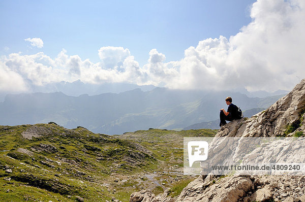 Ten year old boy during a hike  a short rest  Nebelhorn mountain  Allgaeu Alps  Bavaria  Germany  Europe
