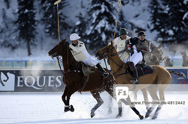 Polo players chasing the ball  Team Maserati against Team Brioni  26. St. Moritz Polo World Cup on Snow  St. Moritz  Upper Engadin  Engadin  Grisons  Switzerland  Europe
