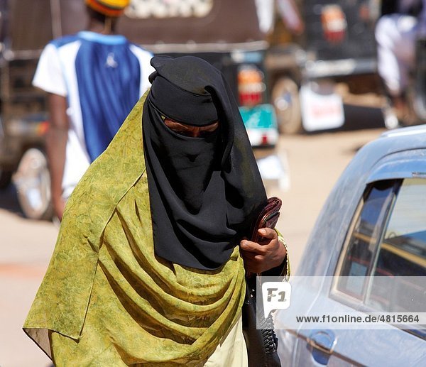 A woman in chador on the street in Dongola