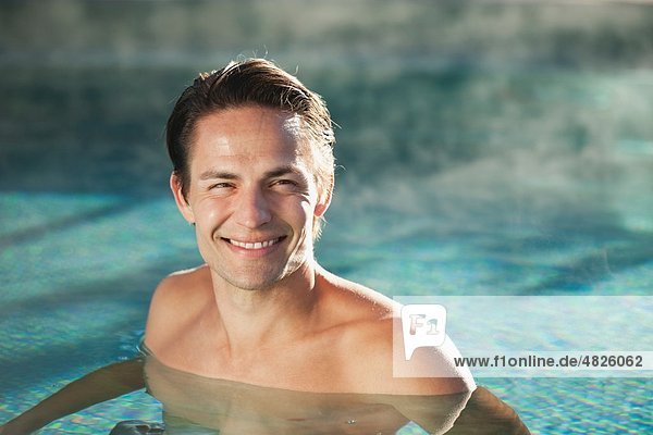 Italien  Südtirol  Mann im Schwimmbad des Hotels urthaler  lächelnd