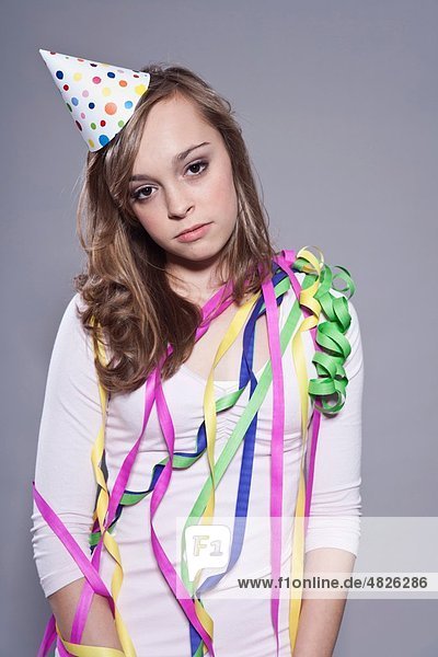Teenage girl with party hat and ribbons