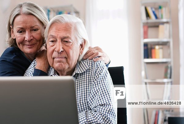 Germany  Wakendorf  Senior couple using laptop
