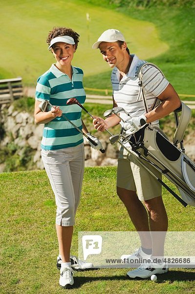 Italy  Kastelruth  Golfers on golf course  smiling  portrait