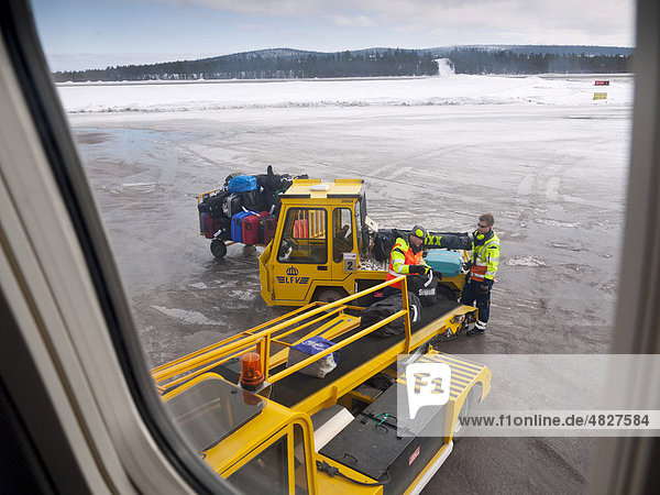 Two employees of the airport loading suitcases of the passengers into the plane  Kiruna Airport  Lapland  Northern Sweden  Sweden  Europe