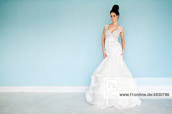 Young woman wearing white wedding dress  studio shot