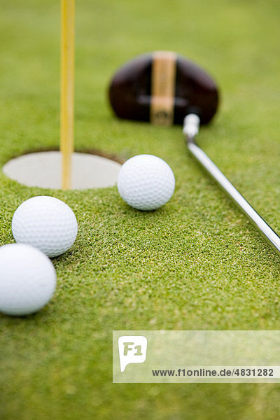 Golf balls and golf hole  close up