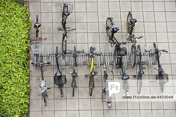 Bicycles parked in bicycle rack  overhead view