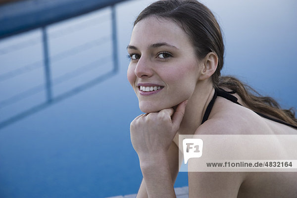 Woman beside pool  portrait