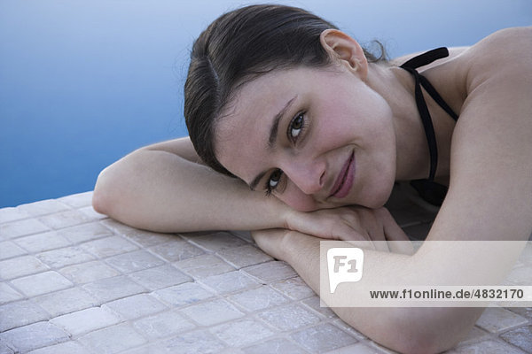 Woman lying beside pool  portrait