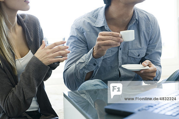 Couple relaxing together with drinks