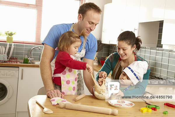 Junge Familie kocht gemeinsam in der Küche
