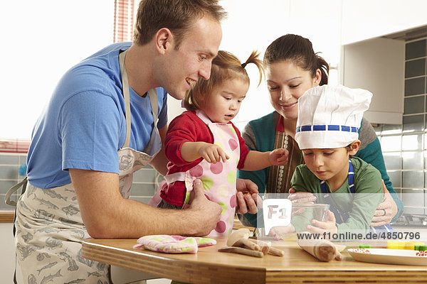 Young family cooking together in kichen