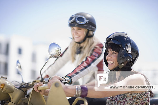 Women riding on a motorbike