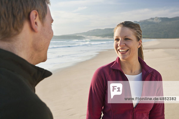 Young couple smiling on beach