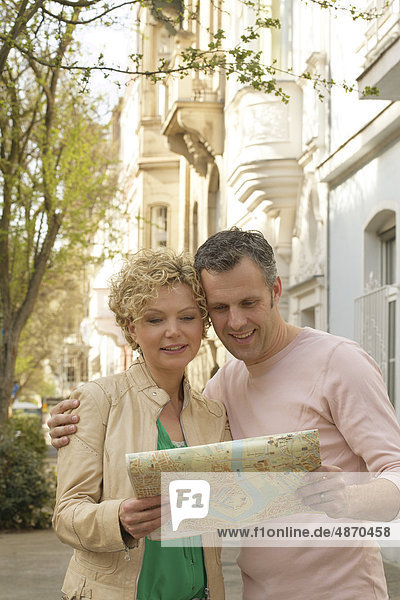 Mature couple with city plan