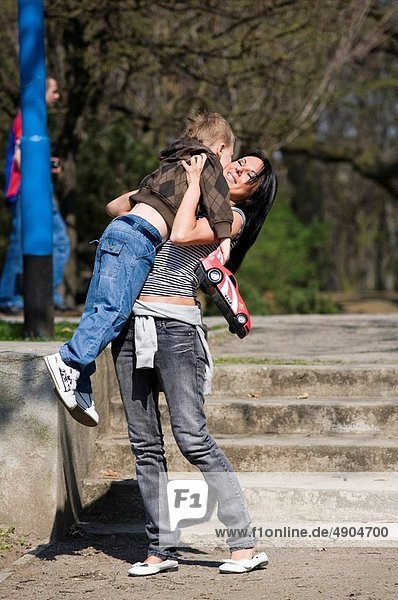 Mother holding son in the park