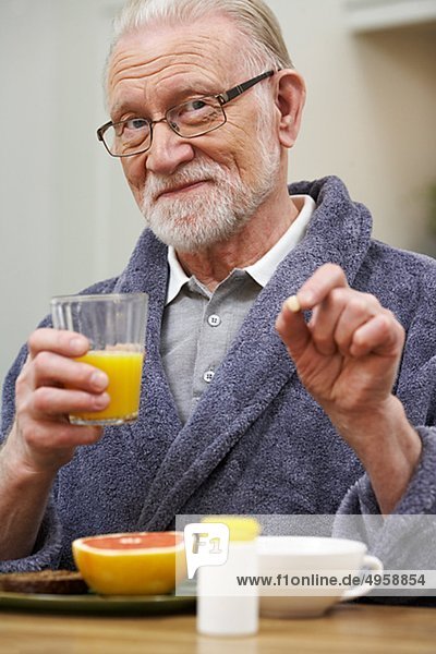 An elderly man having his medicine  Sweden.