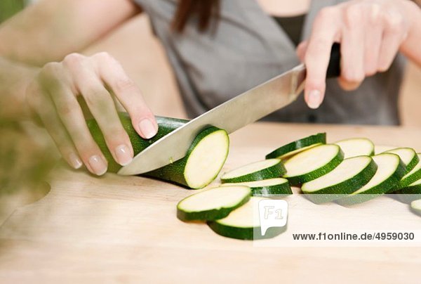 Woman chopping cucumber