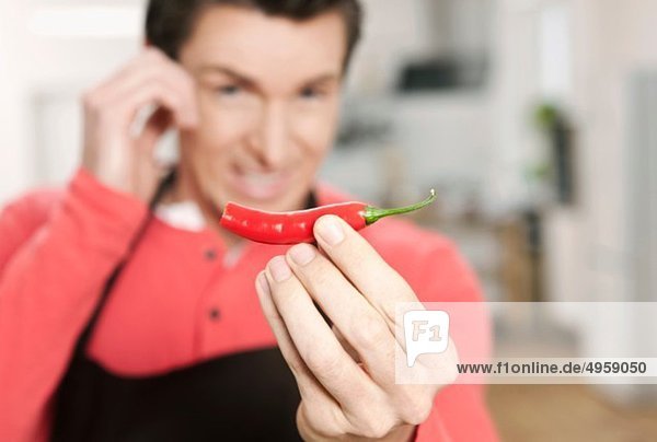 Man holding red chilli