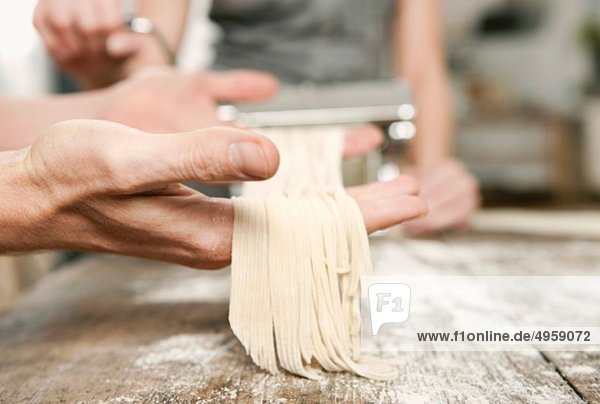 Man and woman making pasta