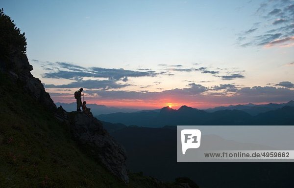 Austria  Salzburg Country  Altenmarkt-Zauchensee  Couple watching sunrise on mountains of Niedere Tauern