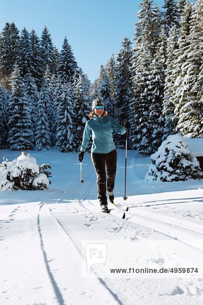 Isar Valley  Senior woman doing cross country skiing