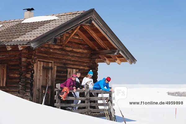 Italy  Trentino-Alto Adige  Alto Adige  Bolzano  Seiser Alm  People standing outside ski resort near railings
