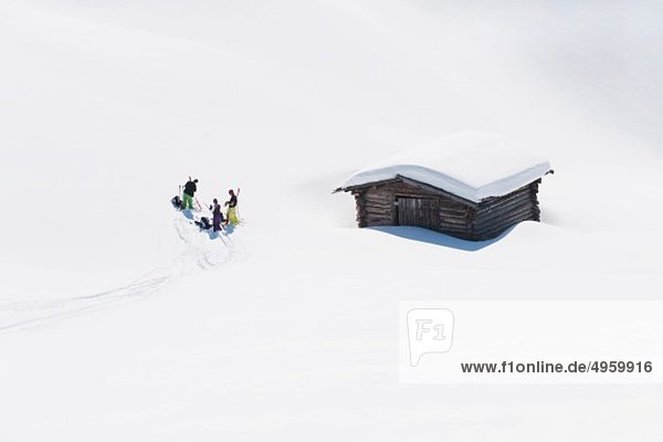 Italy  Trentino-Alto Adige  Alto Adige  Bolzano  Seiser Alm  Group of people near house on ski tour