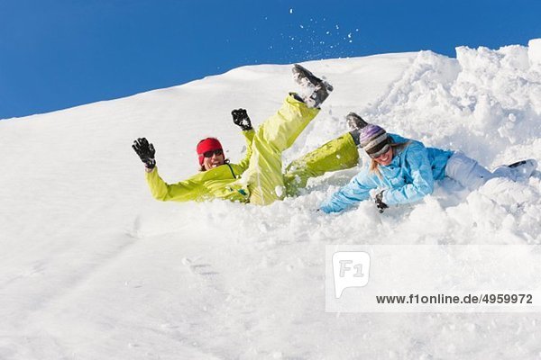 Italy  Trentino-Alto Adige  Alto Adige  Bolzano  Seiser Alm  Man and woman jumping on snow
