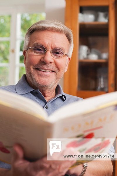 Senior Mann liest Kochbuch  Porträt
