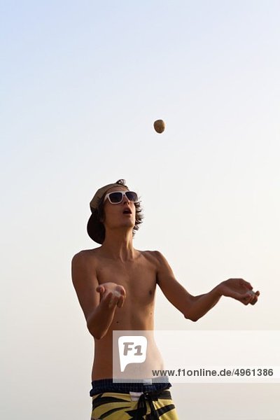 Portugal  Sagres  Algarve  Young man juggling ball