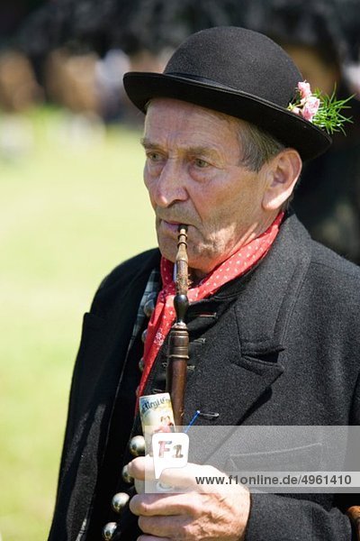 Austria  Upper Austria  Senior men in traditional costume smoking pipe
