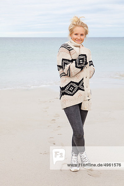Teenage girl standing on beach  portrait