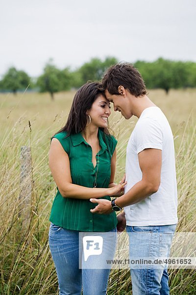 Mid adult couple standing on meadow