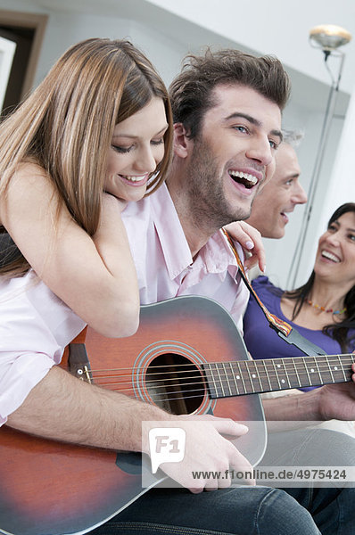 Friends playing guitar and having fun