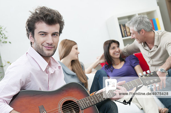 Smiling man with guitar and happy friend