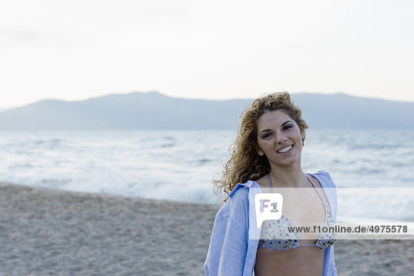 woman on beach smiling at camera