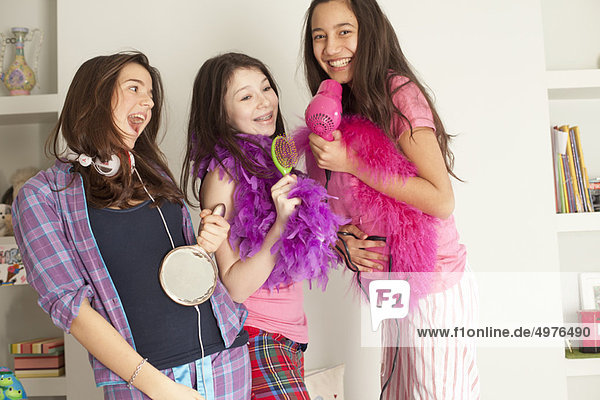 teenage girls singing   wearing pajamas