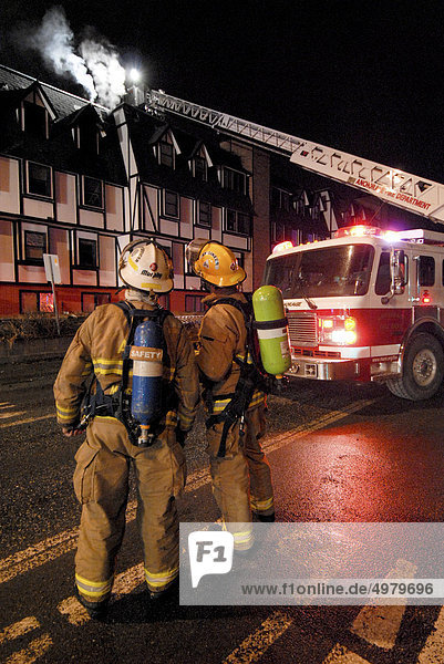 Members of the Anchorage Fire Department work during a cold winter night to extinguish a blaze at the King's Court apartment building near downtown  Southcentral Alaska  Winter