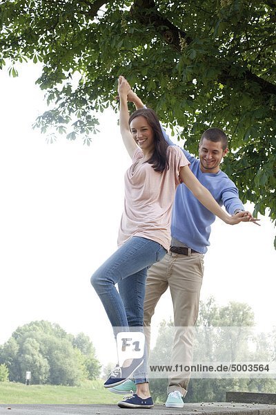 Enthusiastic young couple on a wall